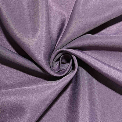 Purple fabric in a swirling pattern, showcasing its smooth texture.