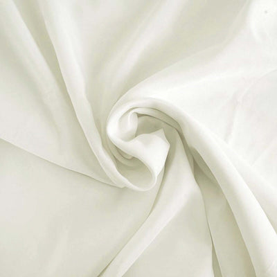 Soft white fabric draped elegantly, showcasing its smooth texture.