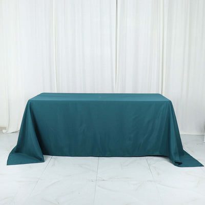 Teal tablecloth draped over a table in a studio setting