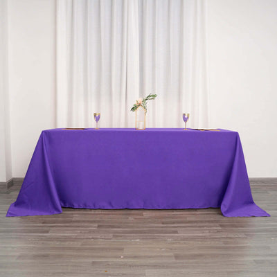 Purple tablecloth draped over a table in a stylish interior setting.