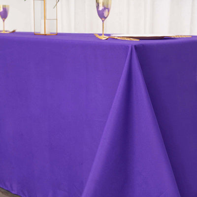 Purple tablecloth draping over a table, perfect for events or decor.