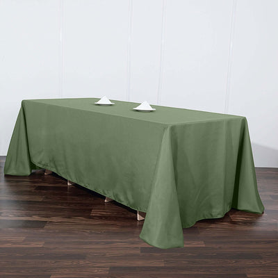 Olive green tablecloth draped over a rectangular table