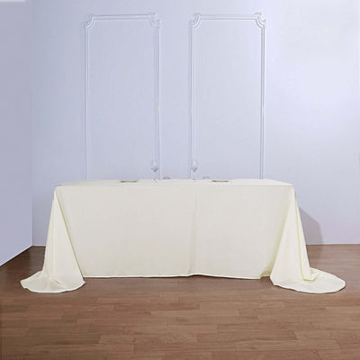 Elegant cream tablecloth draped on a table in a minimalist setting.