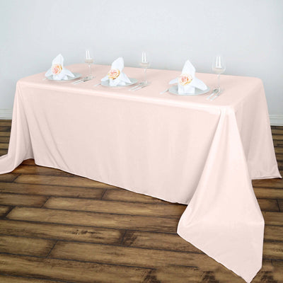 Pink tablecloth draped elegantly on a table set for dining.
