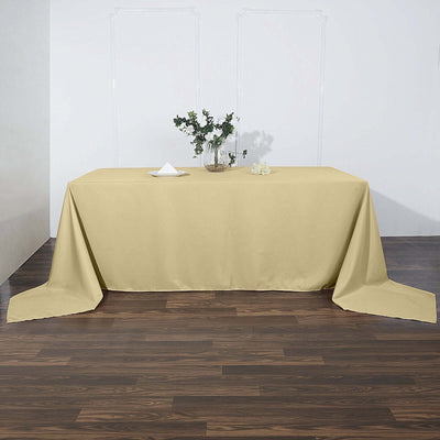 Yellow tablecloth draped over a table in a staged setting.