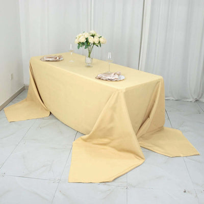 Yellow tablecloth draped elegantly over a table set for dining.