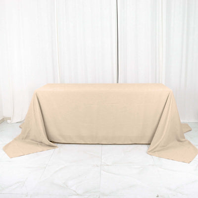 Beige tablecloth draped over a table in a studio setting.