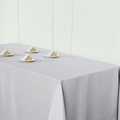 Gray tablecloth with color samples on plates.