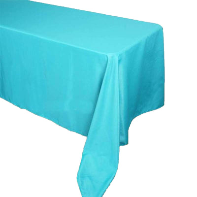 Turquoise tablecloth draped over a table edge