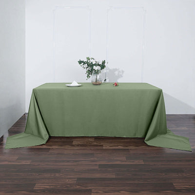 Green tablecloth draped elegantly over a wooden table.