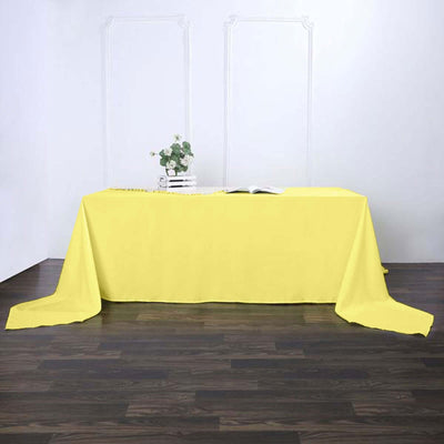 Yellow tablecloth draping elegantly over a wooden table
