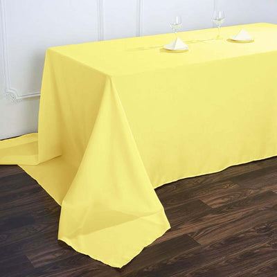 Yellow tablecloth draped over a table with decorative napkins