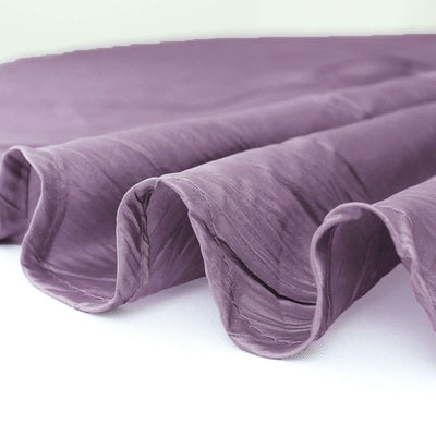 Purple textured fabric with elegant ruffled edges.