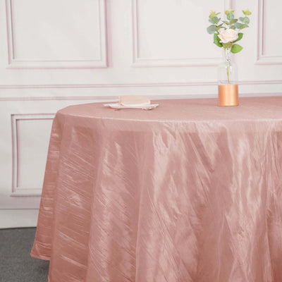 Elegant rose gold tablecloth draped over a table in a styled setting.