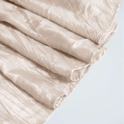 Textured beige fabric with subtle sheen and flowing folds.