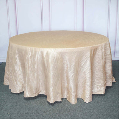 Elegant round table with a shimmering gold tablecloth.