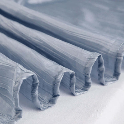 Light blue pleated fabric showcasing texture and drape.