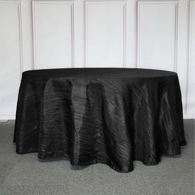 Black tablecloth with a textured finish on a round table.
