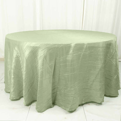 Round green tablecloth with textured fabric.