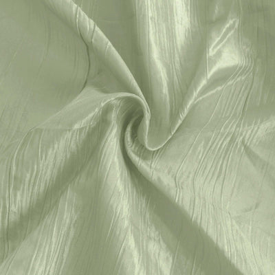 Textured light green fabric in a swirling pattern.