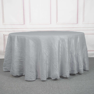 Gray round tablecloth on a table with a textured surface.