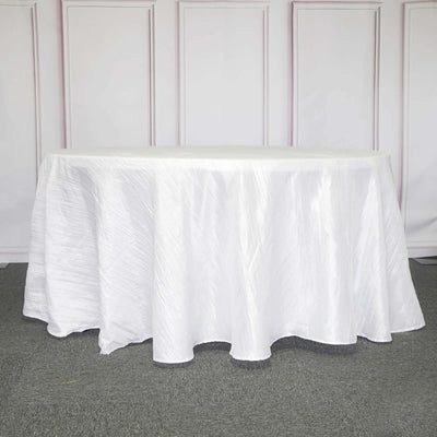 White tablecloth with textured design, draped elegantly over a table.