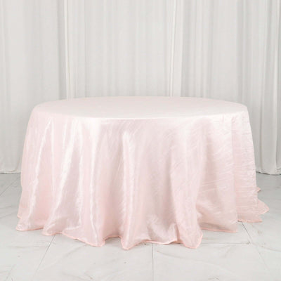 Pink satin round tablecloth on a white surface.