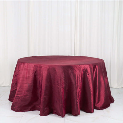 Burgundy round tablecloth on a white backdrop