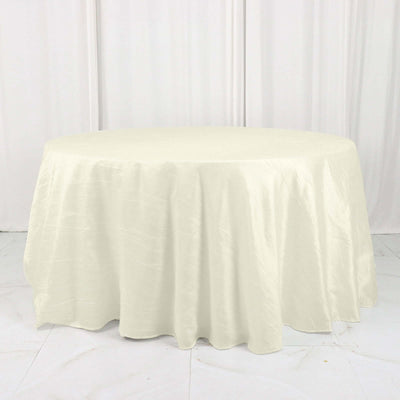 Round ivory tablecloth with elegant draping texture