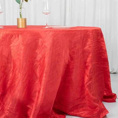 Red tablecloth draped elegantly over a dining table with glassware.