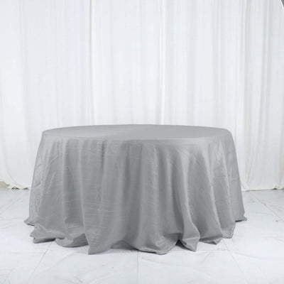 Round gray tablecloth on a plain backdrop