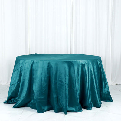 Teal satin tablecloth draped over a round table