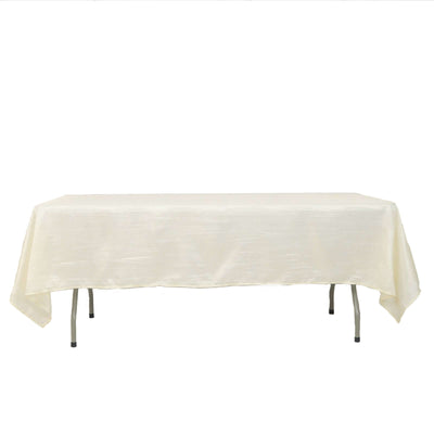 Cream tablecloth on a folding table against a plain backdrop