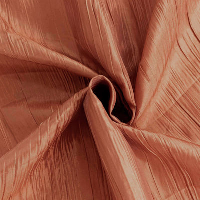 Textured rust-colored fabric with elegant pleats and sheen.