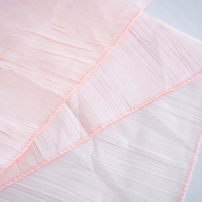 Pink pleated fabric layers on a light background.