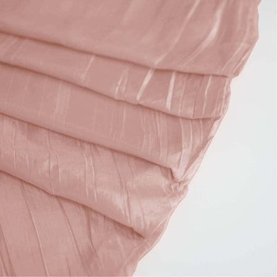 Ruched pink fabric draped elegantly, showcasing its texture and sheen.