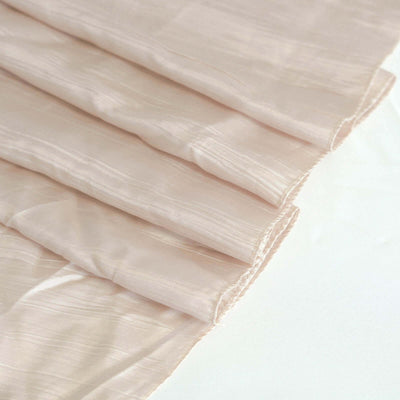 Pale pink textured fabric draped elegantly