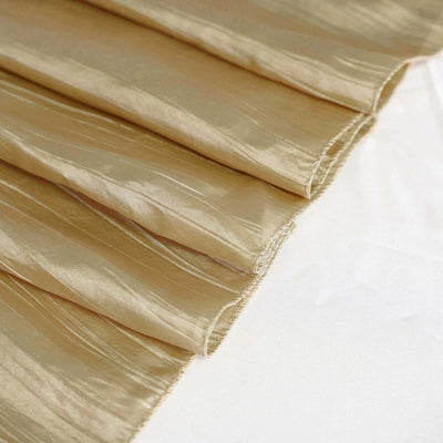 Textured gold fabric draped elegantly, showcasing its sheen and folds.