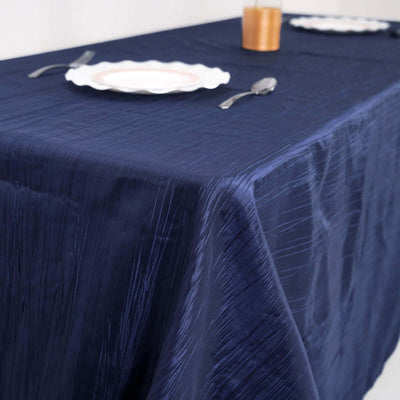 Navy tablecloth draped over a table set for dining.
