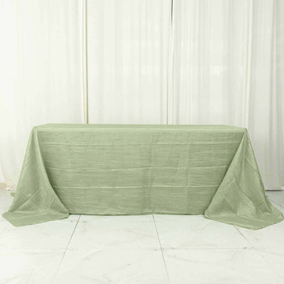 Green tablecloth draped on a table against a light backdrop.