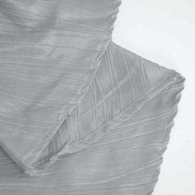 Gray textured fabric draped elegantly on a white backdrop.