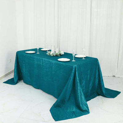 Teal tablecloth draped elegantly over a dining table set for an event.