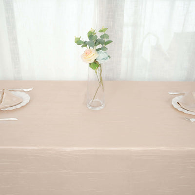 Elegant beige tablecloth with a vase of flowers for dining setup.