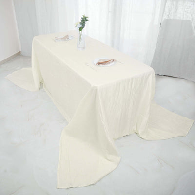 Elegant cream tablecloth draped over a table in a bright room.