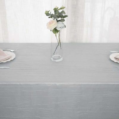 Elegant gray tablecloth with a glass vase and rose centerpiece.