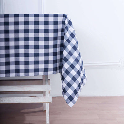Navy and white checkered tablecloth draped over a wooden table edge.