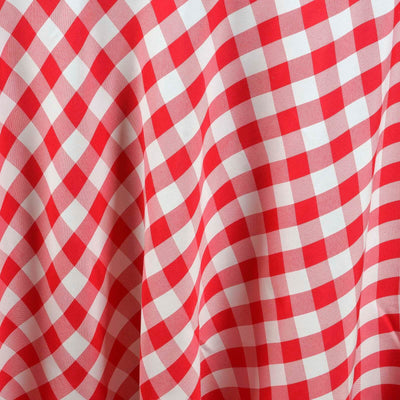 Red and white gingham fabric with a textured pattern.