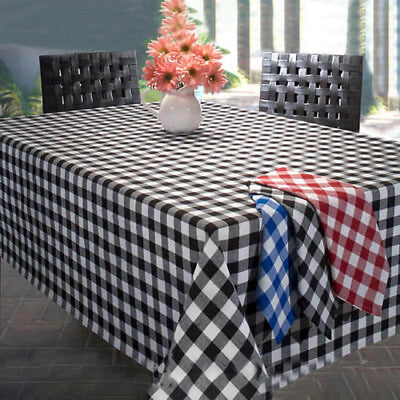 Black and white checked tablecloth on a dining table with floral centerpiece.