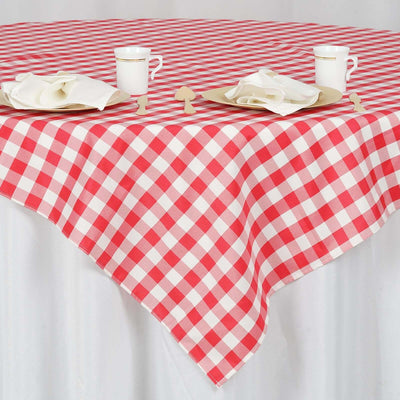 Red and white checked tablecloth on a dining table with plates and napkins.