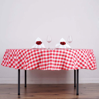 Red and white checkered tablecloth on a dining table with elegant napkin decor.